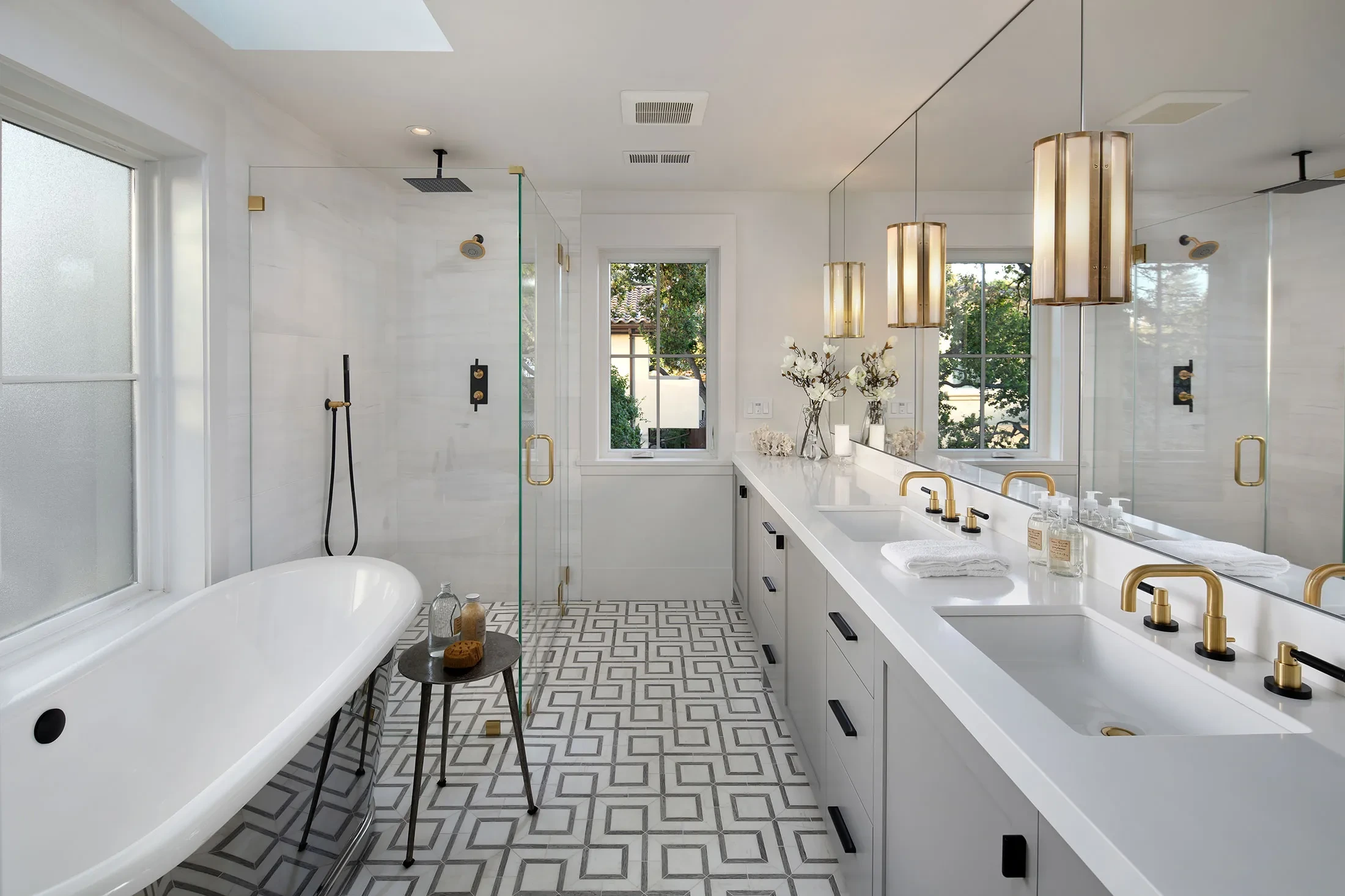 Byron by GHG Builders — primary bathroom with freestanding tub and patterned floor
