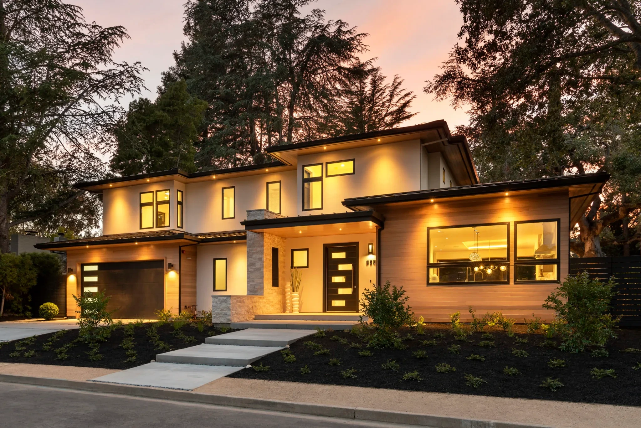 Pineview by GHG Builders — front elevation glowing at dusk